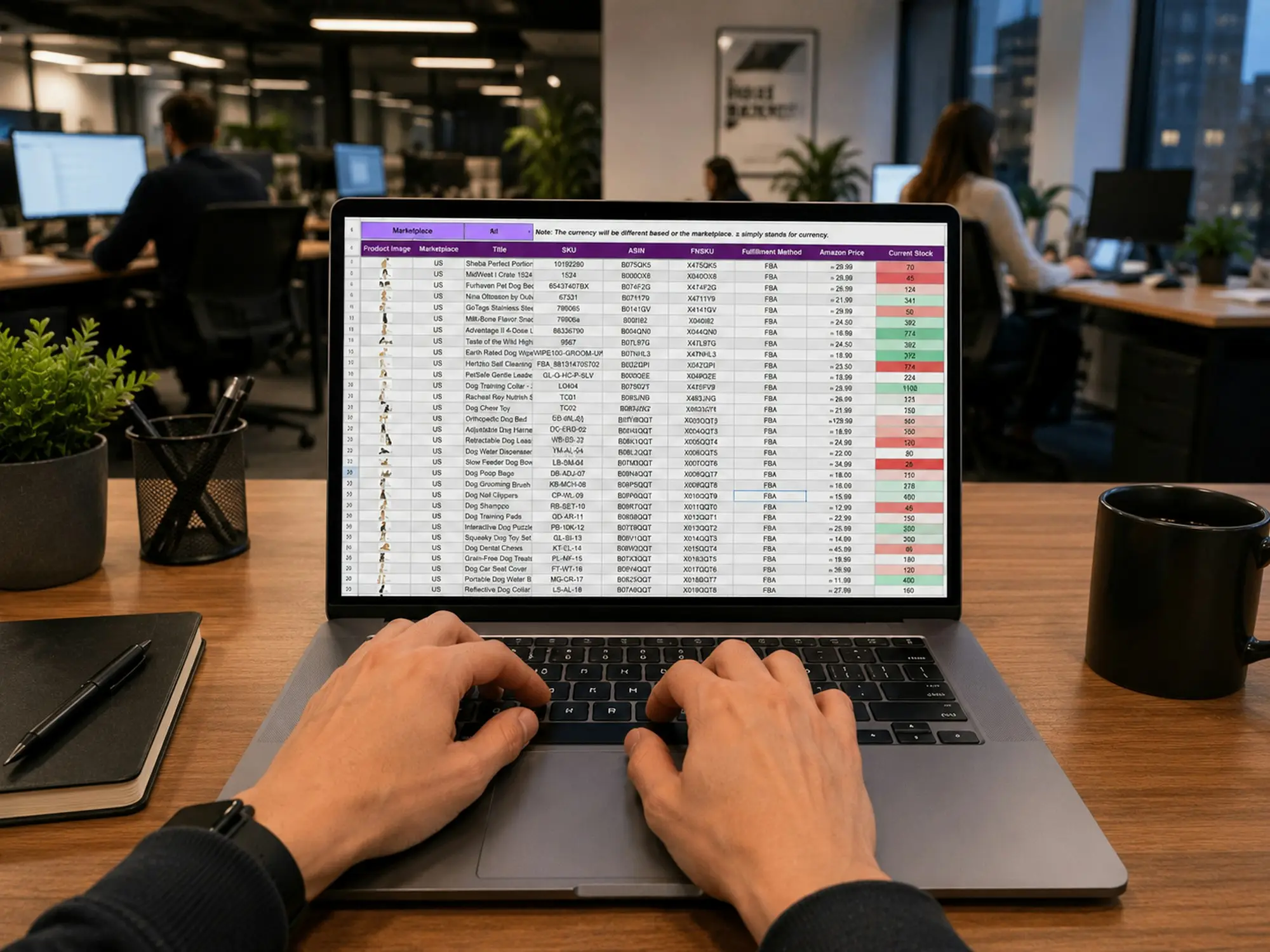 Hands typing on a laptop showing an accounting spreadsheet at a modern office desk