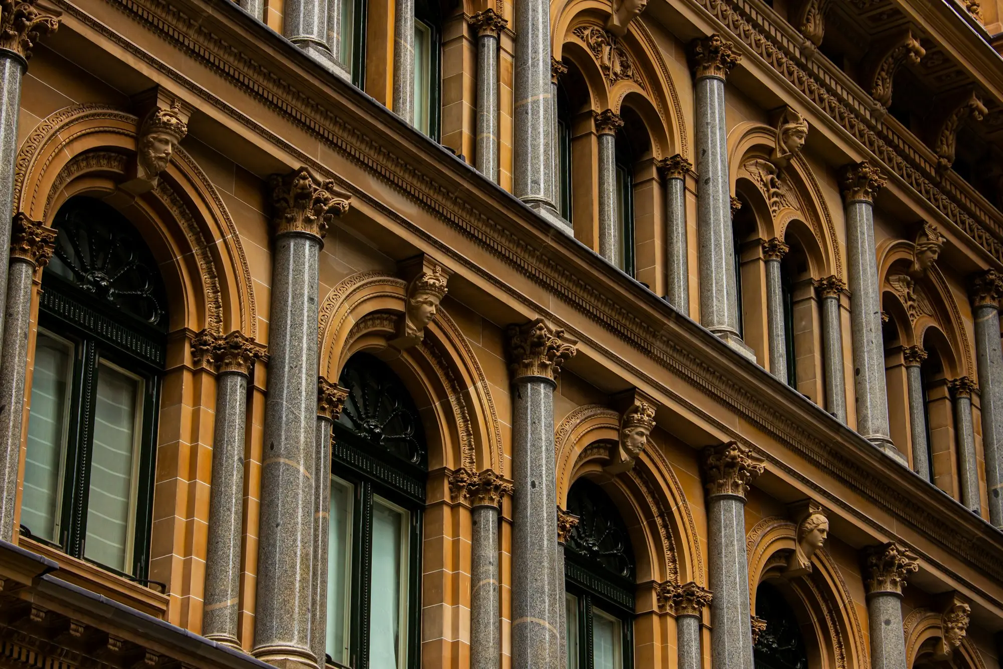 Heritage sandstone facade with arches and columns in the heart of the Sydney CBD