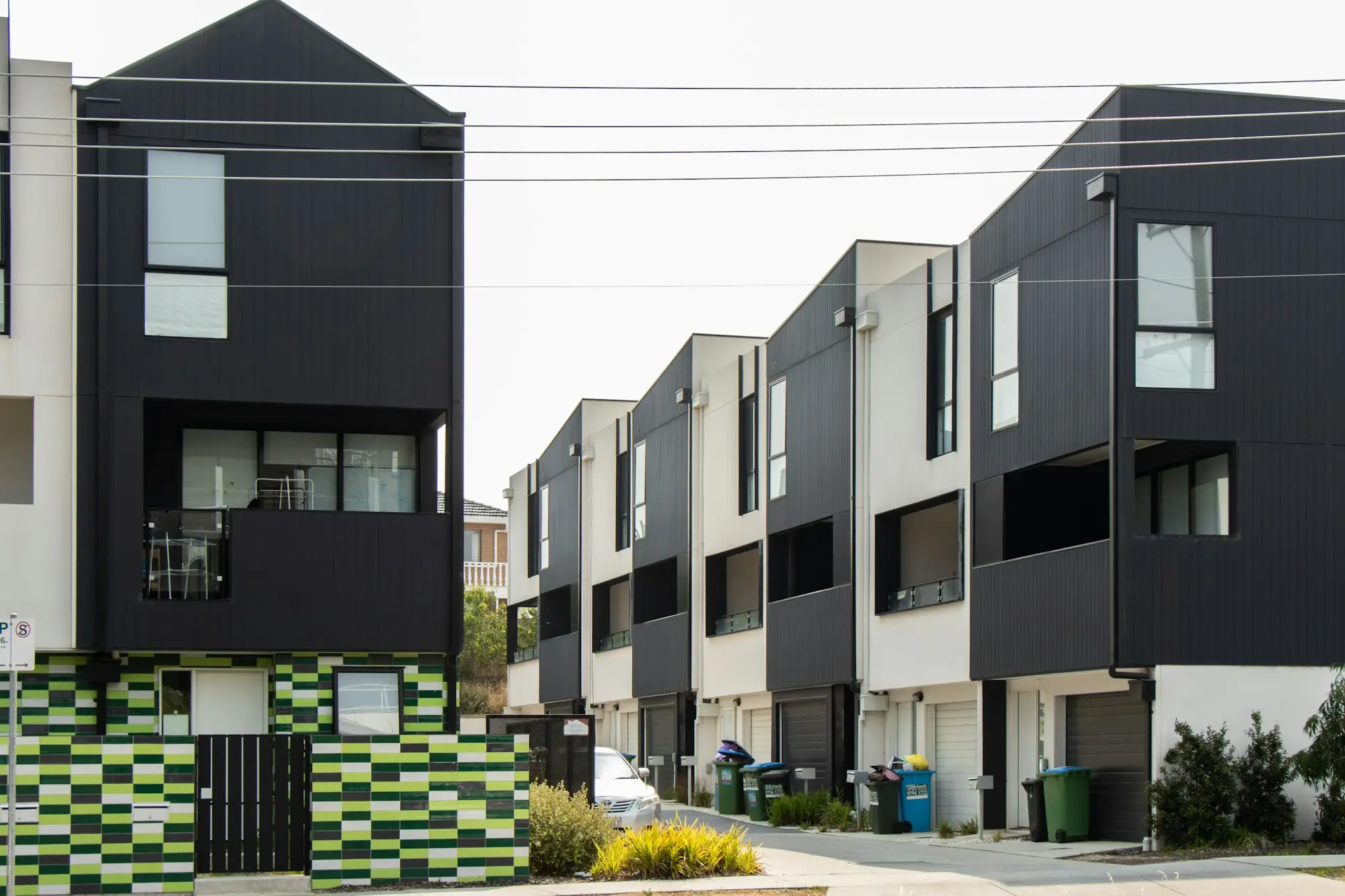 Row of newly built black and white townhouses in a Melbourne residential development