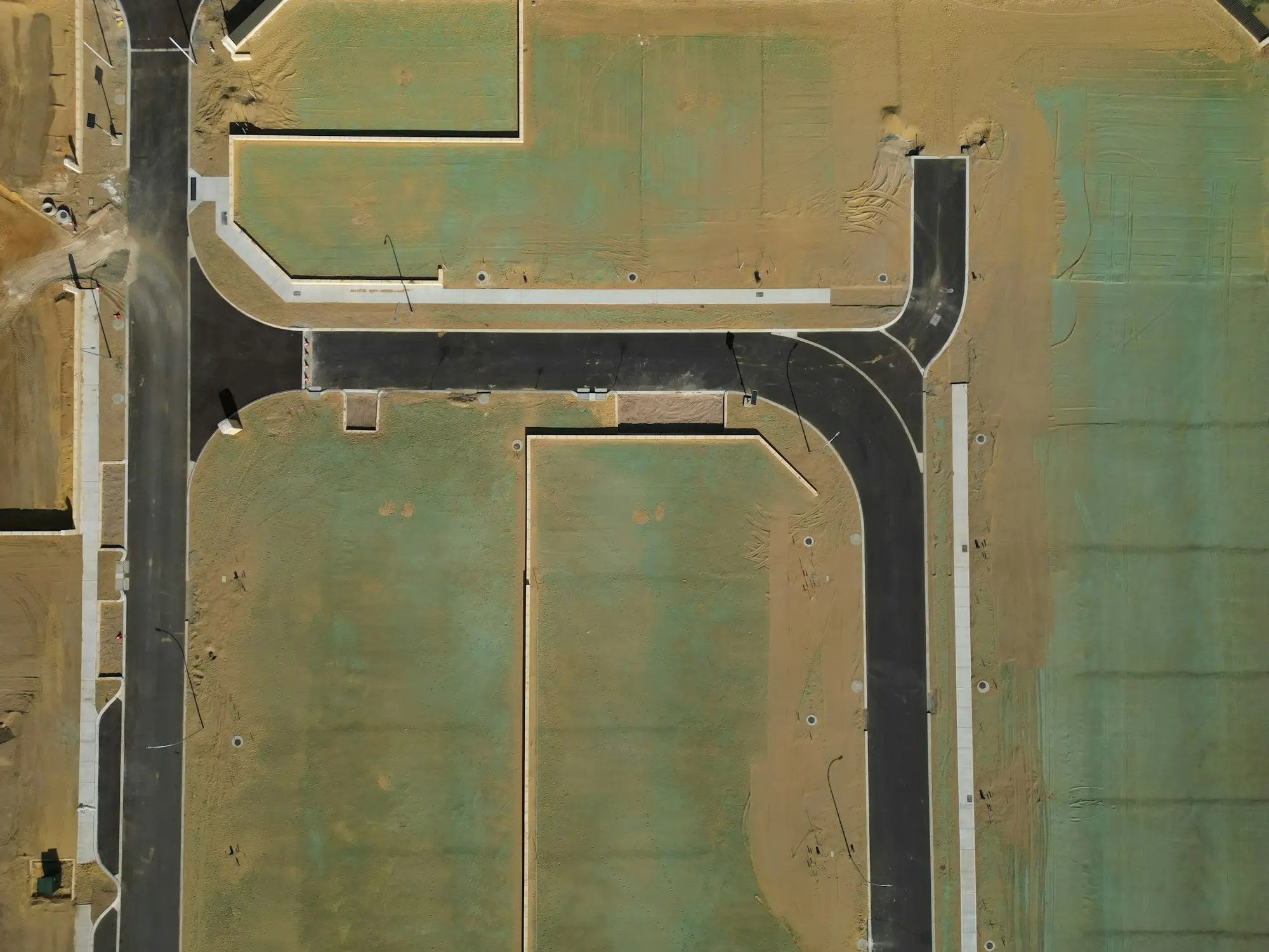 Aerial view of a new residential subdivision with cleared land and new estate roads